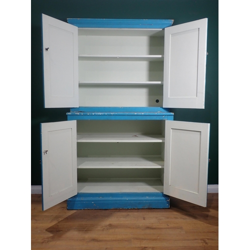 399 - A blue painted Cupboard with a pair of panelled doors enclosing shelves, above another pair of panel... 