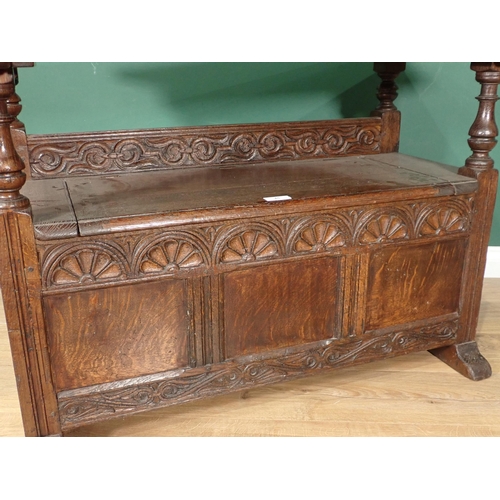 45 - A carved oak Monk's Bench with folding top, 3ft 6in W