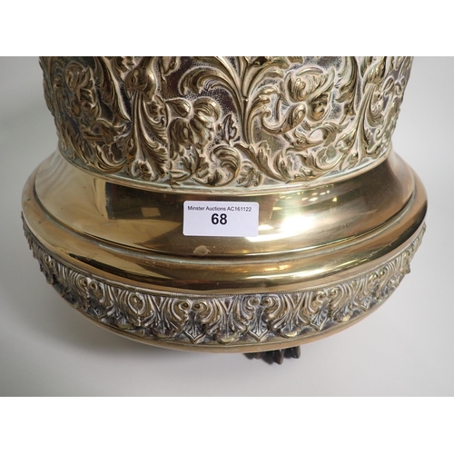 68 - A circular brass Jardiniere with gadroon rim, floral scroll and leafage embossed friezes on paw feet... 