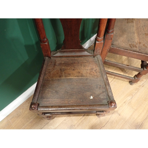 717 - A pair of antique oak Hall Chairs with vase splat backs, solid seats on turned and squared supports