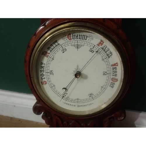 724 - A carved oak Aneroid Barometer, Thermometer, 2ft 11in H