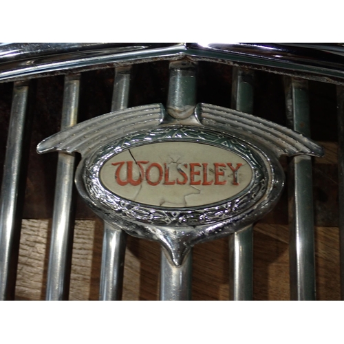 736 - A Wolseley Car Grill and four hub caps