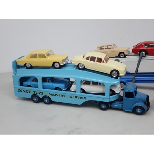 196 - A repainted Dinky Toys Pullmore Car Transporter, three Buses and seven Cars including Jaguar 3.4 lit... 