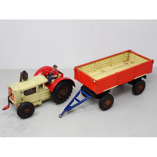 253 - Two German Gama tinplate clockwork Tractors and a Trailer