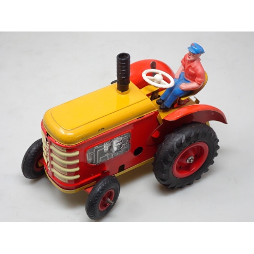 253 - Two German Gama tinplate clockwork Tractors and a Trailer