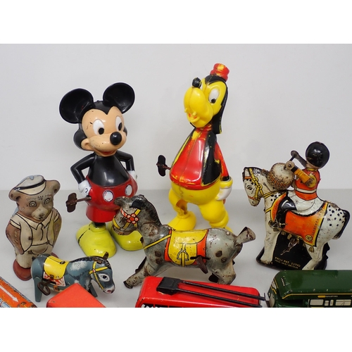 257 - A box of plastic and tinplate Toys including Mickey Mouse, Drummer on horse, Buses and a collection ... 