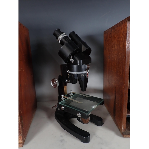 660 - An Olympus Microscope in oak case and a Cooke, Troughton & Simms Microscope in oak case