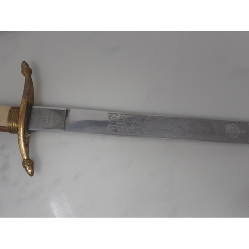 705 - A First World War Naval Dirk by Gieves with clean etched blade in brass mounted leather Scabbard, en... 