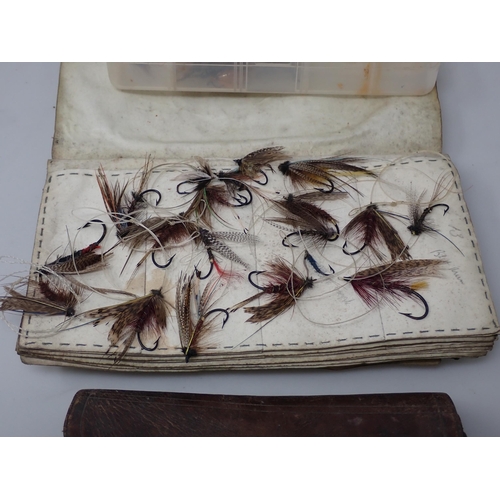 815 - A paper Rig Wallet containing approximately twenty Salmon and Sea Trout Flies, an old leather Fly Wa... 