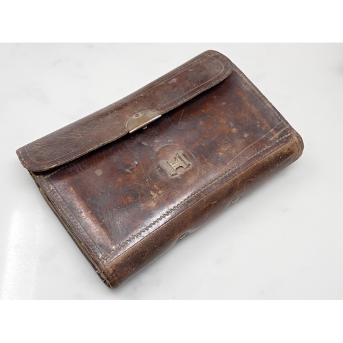 815 - A paper Rig Wallet containing approximately twenty Salmon and Sea Trout Flies, an old leather Fly Wa... 