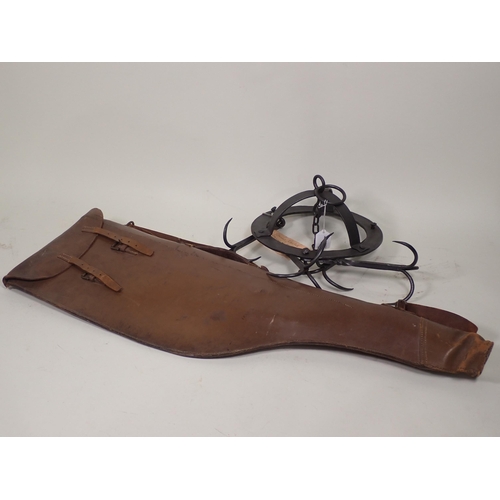 842 - An iron Game Hanger and a leather Leg of Mutton Gun Case