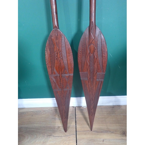 852 - Two carved hardwood Benin Ceremonial Paddles 5ft 1in L and 5ft 4in L