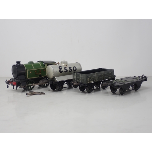 98 - A Hornby 0 gauge clockwork No.101 0-4-0T in L.N.E.R. livery and three Wagons