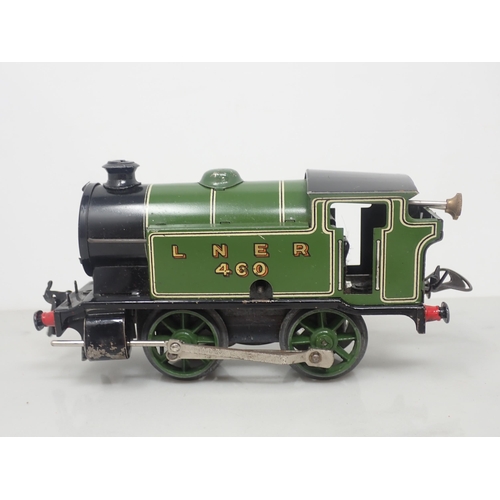 98 - A Hornby 0 gauge clockwork No.101 0-4-0T in L.N.E.R. livery and three Wagons