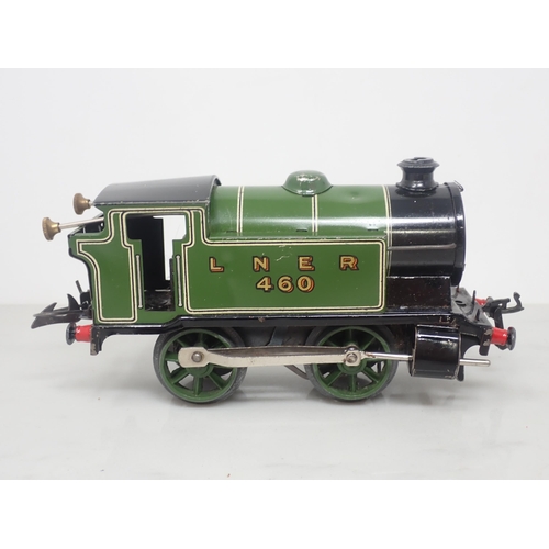 98 - A Hornby 0 gauge clockwork No.101 0-4-0T in L.N.E.R. livery and three Wagons