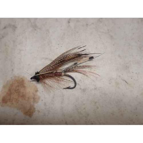 815 - A paper Rig Wallet containing approximately twenty Salmon and Sea Trout Flies, an old leather Fly Wa... 