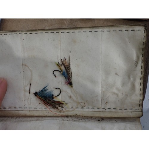 814 - An old leather Fly Wallet containing a quantity of old Salmon Flies in varying conditions, a W.J. Cu... 