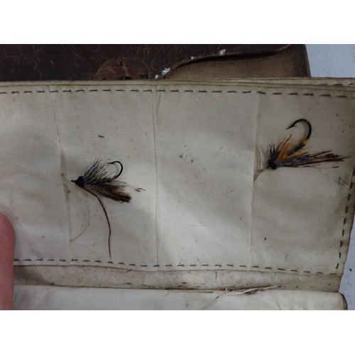 814 - An old leather Fly Wallet containing a quantity of old Salmon Flies in varying conditions, a W.J. Cu... 