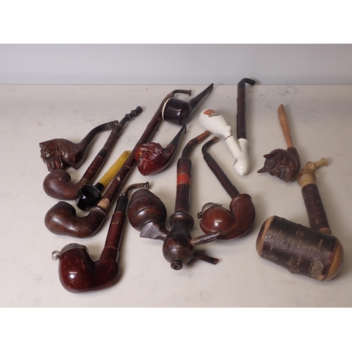 106 - A box full of eight continental and five novelty pipes, including a 'Buttner' patent Bakelite pipe a... 