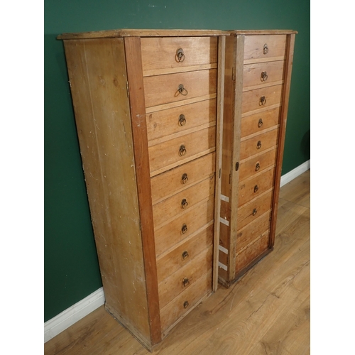 12 - A pair of pine Wellington style Chests, each having ten drawers, 4ft 7in H x 1ft 9in W