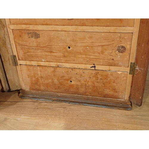 12 - A pair of pine Wellington style Chests, each having ten drawers, 4ft 7in H x 1ft 9in W