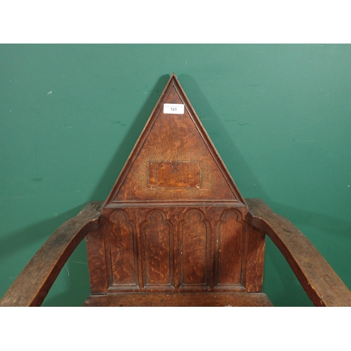 123 - A Gothic influenced oak Elbow Chair with triangular back A/F 3ft 4in H x 2ft W