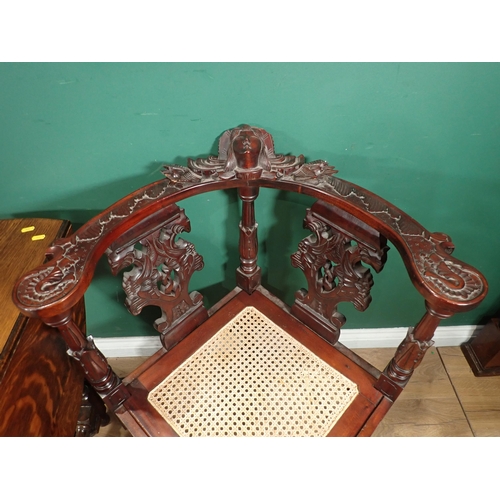 124 - A carved mahogany Corner Chair with cane seat and an oak Sutherland Table