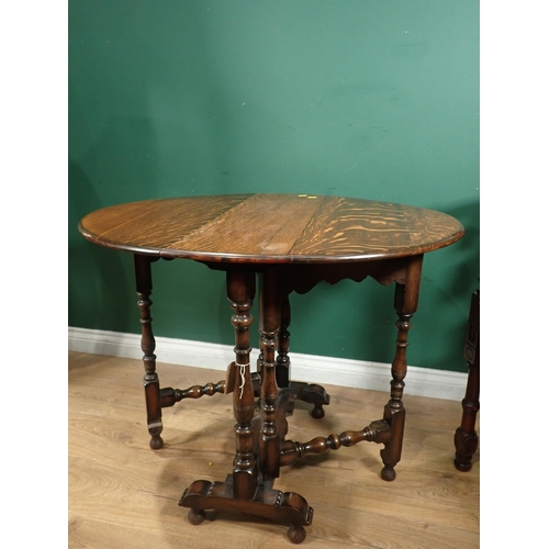 124 - A carved mahogany Corner Chair with cane seat and an oak Sutherland Table