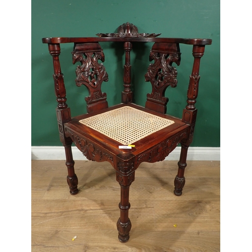 124 - A carved mahogany Corner Chair with cane seat and an oak Sutherland Table