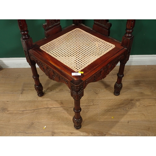 124 - A carved mahogany Corner Chair with cane seat and an oak Sutherland Table