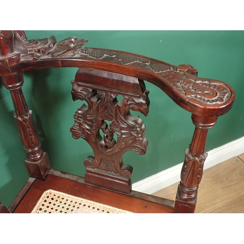 124 - A carved mahogany Corner Chair with cane seat and an oak Sutherland Table