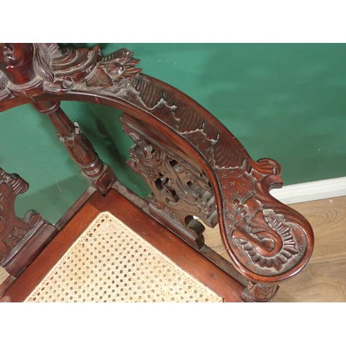 124 - A carved mahogany Corner Chair with cane seat and an oak Sutherland Table