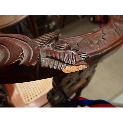 124 - A carved mahogany Corner Chair with cane seat and an oak Sutherland Table