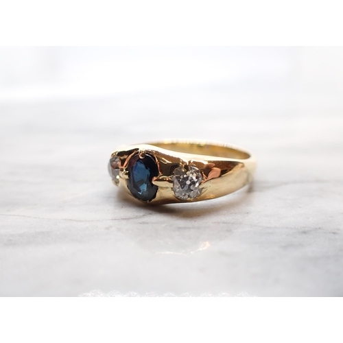 160 - A Sapphire and Diamond three stone Ring claw-set oval-cut sapphire between two old-cut diamonds, sta... 