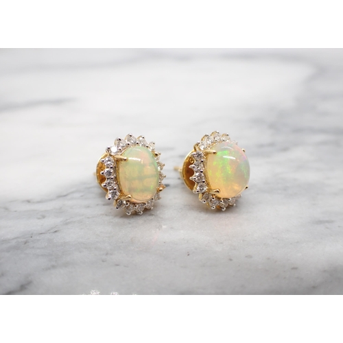 166 - A pair of Opal and Diamond Cluster Earrings each claw-set oval opal cabochon within a frame of brill... 