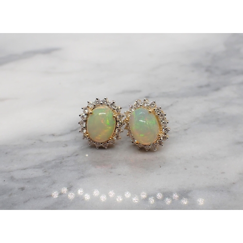 166 - A pair of Opal and Diamond Cluster Earrings each claw-set oval opal cabochon within a frame of brill... 