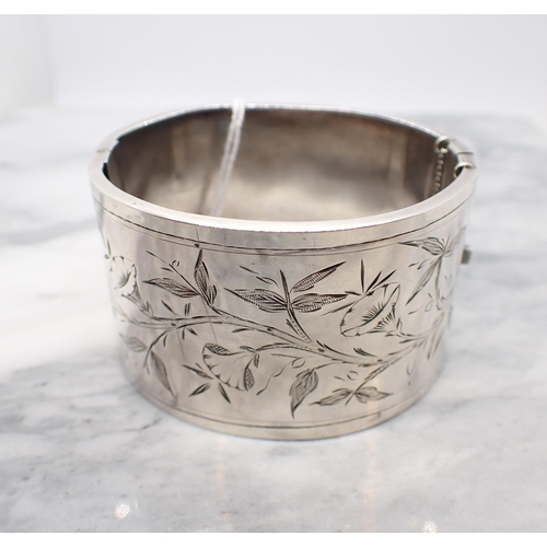 168 - A silver hinged Cuff Bangle with floral bright-cut engraving to front, marked Sterling