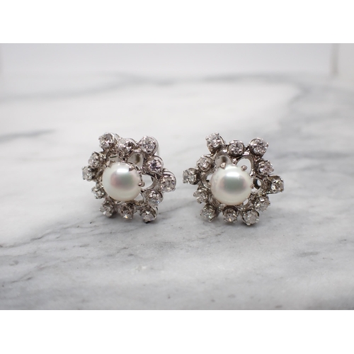 177 - A Pair of Cultured Pearl and Diamond Ear Clips each claw-set half pearl within openwork frame set br... 