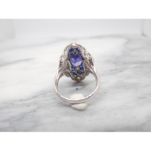 183 - An Art Deco style Tanzanite, Sapphire and Diamond Cocktail Ring millegrain-set oval-cut tanzanite be... 