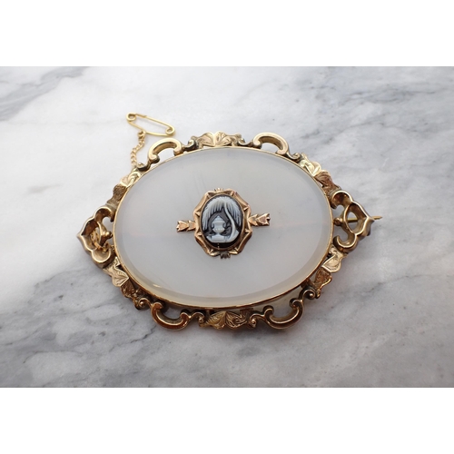 188 - A Victorian oval Chalcedony Mourning Brooch with small carved cameo of an urn to centre in intricate... 