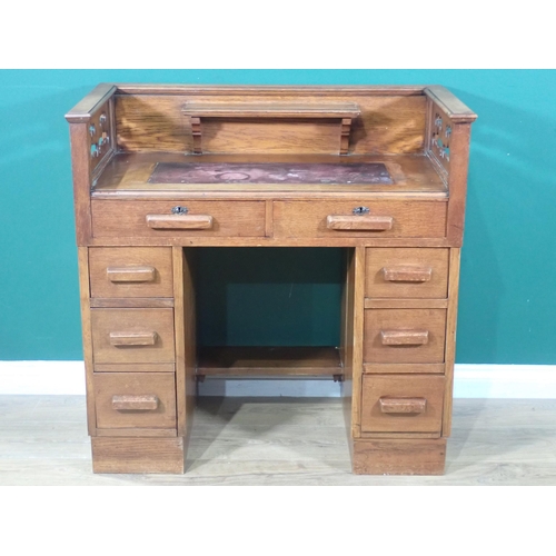 2 - An Arts and Crafts oak kneehole Desk with pierced gallery above eight drawers 3ft W x 3ft H