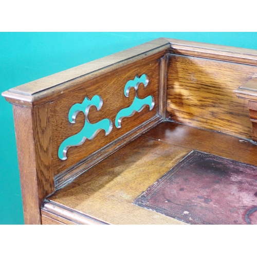 2 - An Arts and Crafts oak kneehole Desk with pierced gallery above eight drawers 3ft W x 3ft H