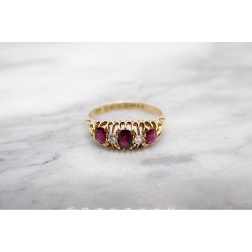 205 - A Ruby and Diamond five stone Ring three graduated oval-cut rubies with two old-cut diamonds between... 