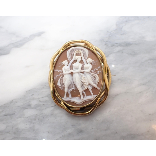 218 - A carved shell Cameo Brooch depicting the three graces in woven yellow metal frame