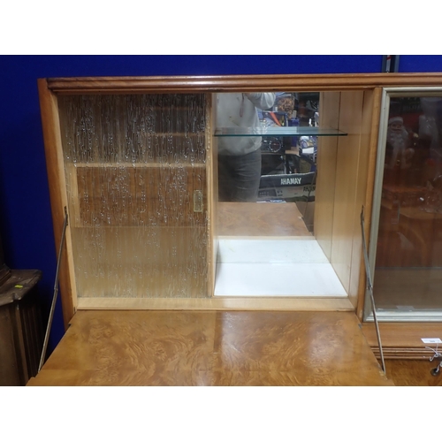 309 - An Art Deco walnut veneered Unit with glazed upper section above two drawers and two cupboard doors ... 