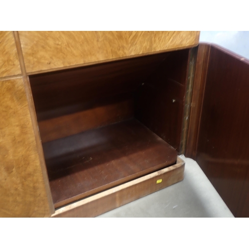 309 - An Art Deco walnut veneered Unit with glazed upper section above two drawers and two cupboard doors ... 