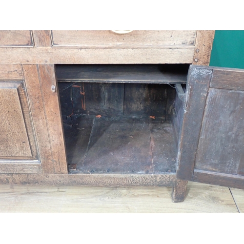 337 - A Georgian oak enclosed Dresser and Rack fitted three frieze drawers above pair of fielded cupboard ... 