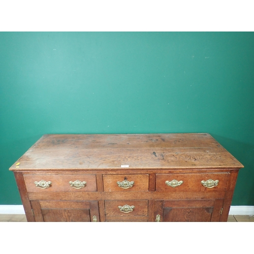 338 - A Georgian oak Dresser Base fitted three frieze drawers above pair of cupboard doors flanking dummy ... 