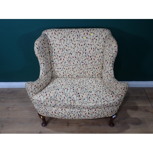 342 - A small wingback Settee with cream floral upholstery mounted on cabriole supports and pad feet 3ft 8... 