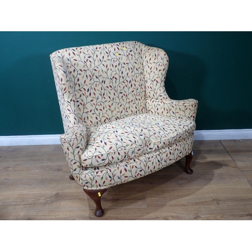 342 - A small wingback Settee with cream floral upholstery mounted on cabriole supports and pad feet 3ft 8... 